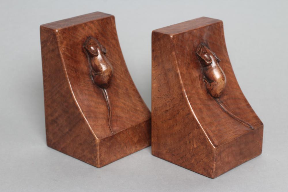 ROBERT THOMPSON, a pair of adzed oak bookends of oblong form, the dished sides with carved mouse