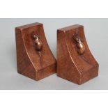 ROBERT THOMPSON, a pair of adzed oak bookends of oblong form, the dished sides with carved mouse