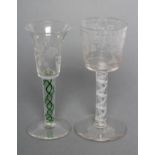 A WINE GLASS in mid 18th century style, the bucket bowl engraved with urns of flowers and swags of