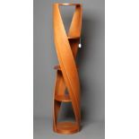 A TOM SCHNEIDER DNA WHOLE TWIST CHERRYWOOD SHELVING UNIT, modern, with six circular shelves, 17" x