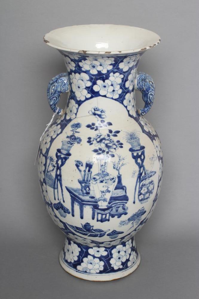 A CHINESE PORCELAIN VASE of bombe cylindrical form with two elephant head handles, painted in