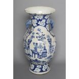 A CHINESE PORCELAIN VASE of bombe cylindrical form with two elephant head handles, painted in