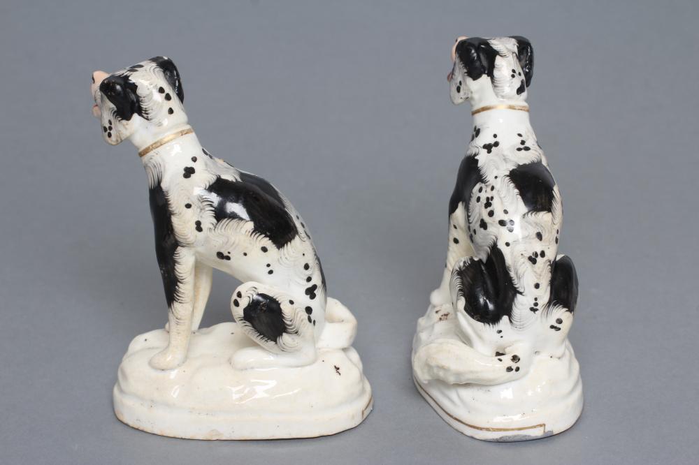 A PAIR OF STAFFORDSHIRE PORCELANEOUS BLACK AND WHITE SPANIELS, c.1830, modelled seated with free - Image 3 of 4