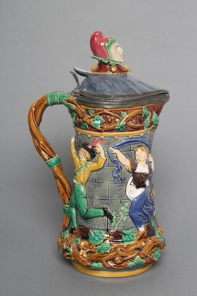 A VICTORIAN MINTON MAJOLICA "TOWER" JUG, the pewter hinged cover with Mr Punch finial, impressed