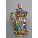 A VICTORIAN MINTON MAJOLICA "TOWER" JUG, the pewter hinged cover with Mr Punch finial, impressed