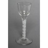 A GEORGE III WINE GLASS, the ogee bowl on a double series twist of a white opaque multi-spiral
