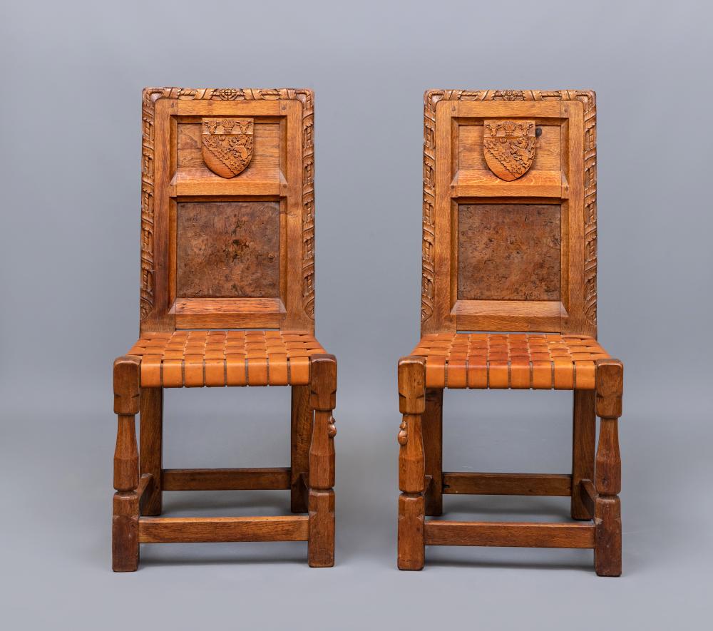 A PAIR OF ROBERT THOMPSON CARVED OAK HALL CHAIRS, the twin panel back bearing the Horlick crest