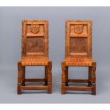 A PAIR OF ROBERT THOMPSON CARVED OAK HALL CHAIRS, the twin panel back bearing the Horlick crest