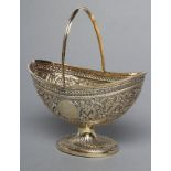 A VICTORIAN GILDED SILVER SUGAR BASKET, maker Henry Holland, London 1879, of oval form with reeded