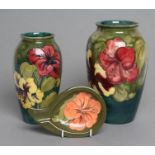 A MOORCROFT POTTERY HIBISCUS PATTERN VASE, mid 20th century, of ovoid form, tubelined and painted in