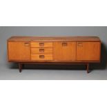 A TEAK LOW SIDEBOARD, mid 20th century, the moulded edged top with ledge back, the fascia with a