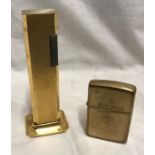 Dunhill tallboy gold plated table cigarette lighter 11cms h and brass zippo petrol lighter.