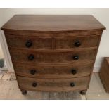 A 19thC mahogany 4 height bow fronted chest of drawers. Two short drawers over 3 long on turned