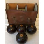 Four Lignum Vitae bowls in a vintage case.