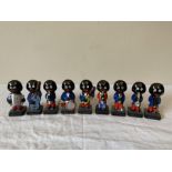 A group of 9 ceramic glossy Band Robertson Golly figures, possibly Carlton Ware. 9 marked at