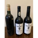 Two bottles of Warre's 1983 vintage port and a bottle of Chateau des Carmes Haut-Brion (lacking