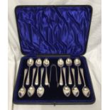Hallmarked silver cased set of 12 teaspoons plus sugar tongs with engraved handles. J.S. Sheffield
