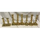 Selection of brass candlesticks. Set of three 20cms h, a pair 15cms h and three singular