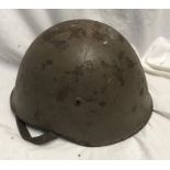 A WW II Italian Military helmet. Condition ReportLots of paint wear, surface rust. Chin strap