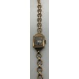 A 9ct gold ladies wristwatch and strap. 12.2gms total weight. Condition ReportNot in working