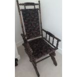 A 19thC upholstered American rocking chair. Condition ReportArm slightly loose.