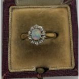 Opal and diamond cluster dress ring set in 18ct gold, size M, 3.6gms total weight. Condition