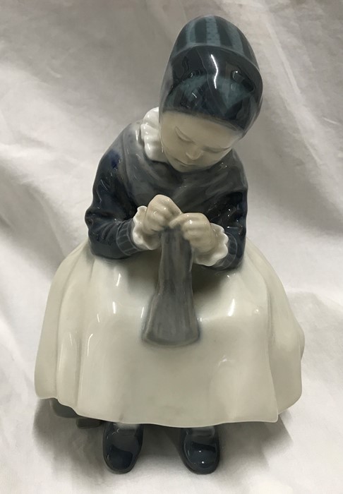 Royal Copenhagen Denmark figurine, Amager girl sewing 16cms h x 11cms w, signed to the base. Model
