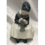 Royal Copenhagen Denmark figurine, Amager girl sewing 16cms h x 11cms w, signed to the base. Model