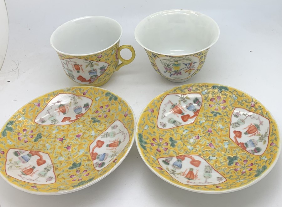 Chinese famille jeune tea bowl, cup and two saucers with square seal marks. Condition ReportNibble