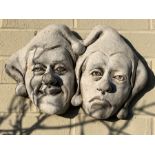 Wall masks of clowns, reconstituted stone. 41 w x 25cms h.