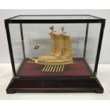 A 24ct gold plated Korean Turtle ship model in a glazed display case. Case measures 32 w x 19 d x