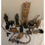 A large quantity of mostly wooden, ceramic and soapstone figures plus a beadwork whip and skin