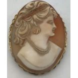 Shell cameo brooch of a female head mounted in 9ct gold, 4.5 x 3.5cms, 11.7gms total weight.