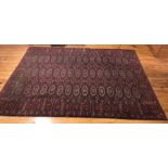 A deep red ground rug. 265 x 179cms.Condition ReportSome wear in places.