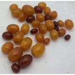 Loose butterscotch and cherry amber beads, largest 2.5cms approx. 51.7gms approx total weight.