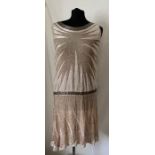 A vintage French beaded evening dress, labelled Made in France, 44. 99cms l, under arm to arm laid