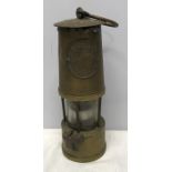 Brass miners lamp The Protector. Eccles, Manchester. 25 h x 8.5cms w. Condition ReportSmall split to