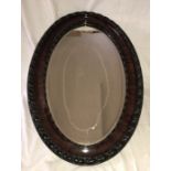 Large oval framed gesso wood effect bevel edged wall mirror. Frame 54 w x 82cms h, Condition