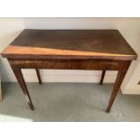 A 19thC mahogany fold over tea table on square tapered legs and spade feet with string inlay to