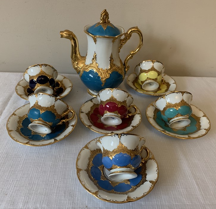 A continental harlequin and gilt porcelain coffee service with blue mark to base, six cups and