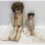 Two early 20thC dolls, Heubach 275 pot headed doll with leather body, 42cms h and a large Unica