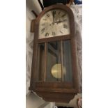 An oak arched top wall clock 62 w x 31cms. Condition ReportCase in good condition. Works untested.