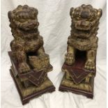 Pair of Chinese carved gilt painted wooden large Foo dogs. 52cms h x 22cms base x 33cms d. Condition