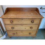 A three height pine chest of drawers with gallery back on bun feet. 92 w x 45 d x 86cms h. Condition
