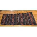 A red and blue patterned long runner, 90 x 211cms. Tapering at ends.Condition ReportSeveral holes in