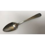 A Georgian silver teaspoon, Hallmark rubbed, engraved initials S B. 11.8gms.