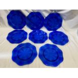 A set of eight good quality heavy cobalt blue glass charger plates, with a scalloped edge and a