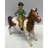 A Beswick Huntsgirl on a skewbald pony. Approx. 14cms h x 15cms l.Condition ReportVery good