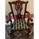 An 18thC style child's carved armchair in the Chippendale manor. 64 h to back, 30 h to seat.