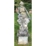 A reconstituted stone garden ornament of a female figure with flower basket seated on tree stump and